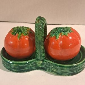 Vintage ceramic salt and pepper shaker set, tomatoes in a green basket.